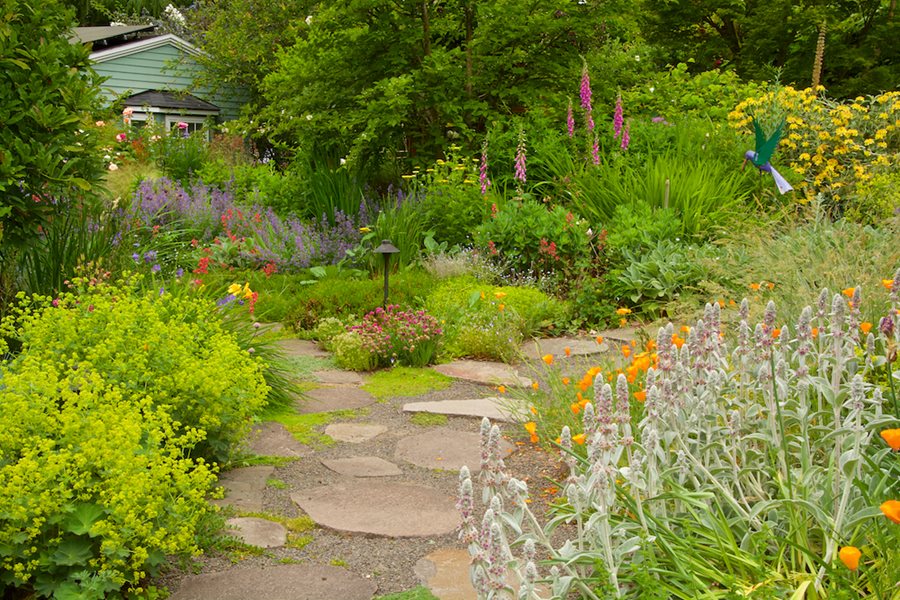 Person taking a refreshing break outdoors in a peaceful garden setting